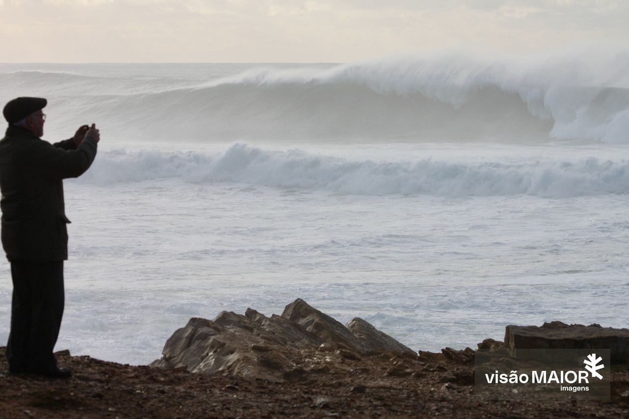 Um homem a tirar fotografias às ondas
